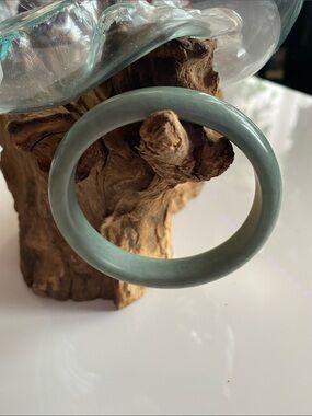 Green one of a kind jade bangle. Comes with a crystal ring.